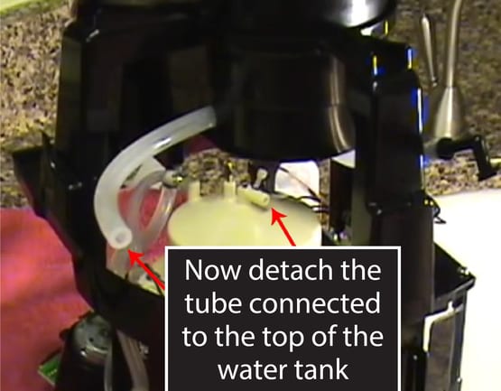 Detach the tube on the top of the water tank